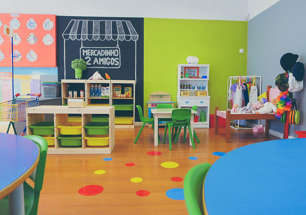 Preschool classroom with colorful furniture and play area