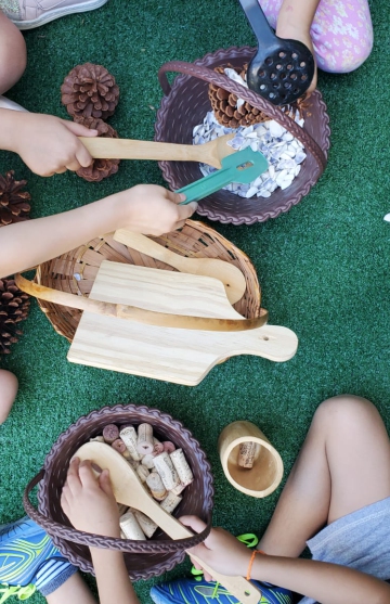Preschool children playing with wooden toys and natural materials