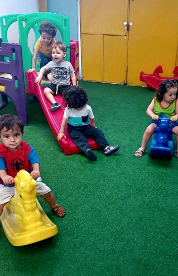 Preschool children playing on playground equipment