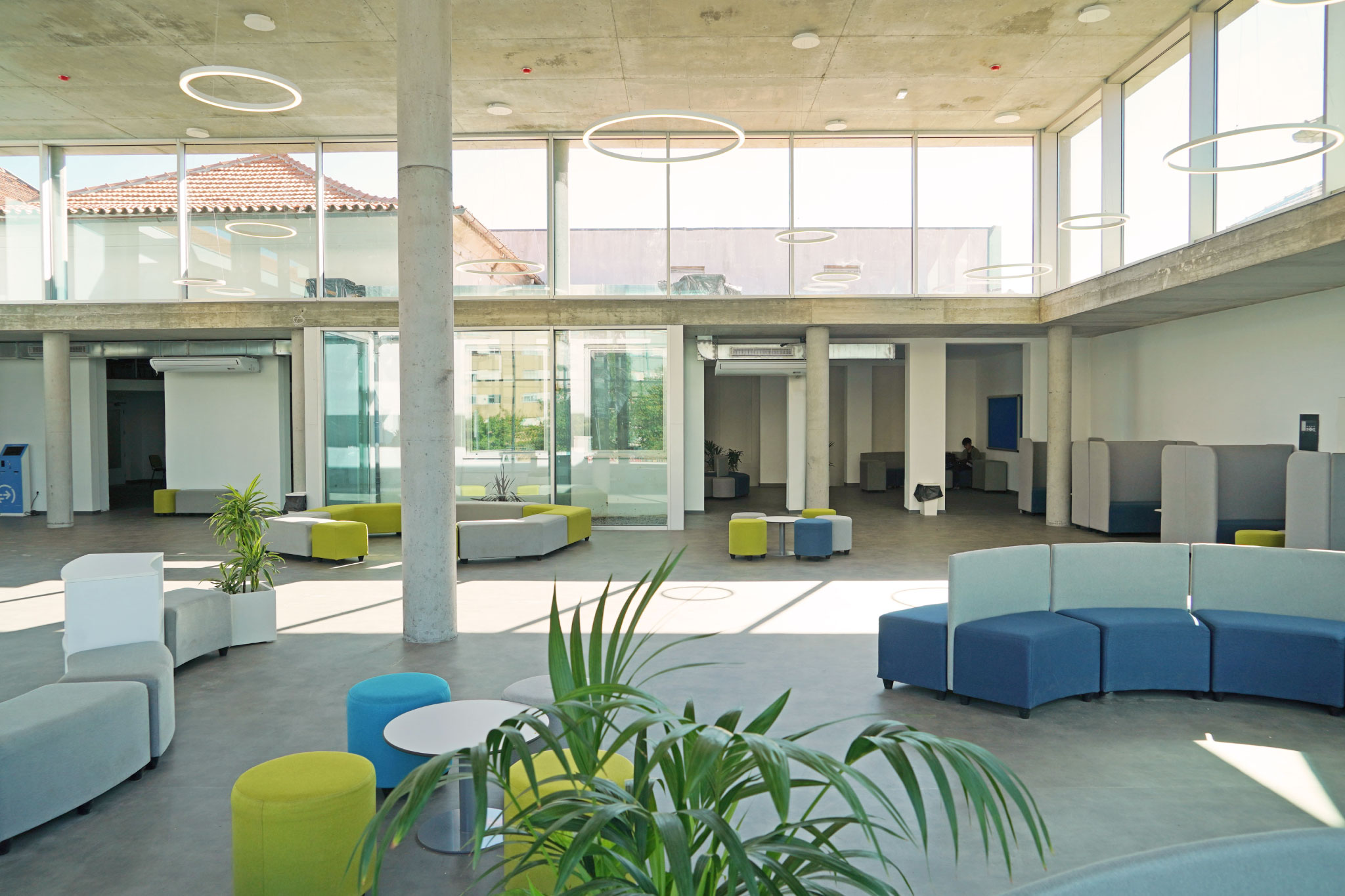 Modern and spacious interior of CJD International School, featuring comfortable seating areas and large windows.