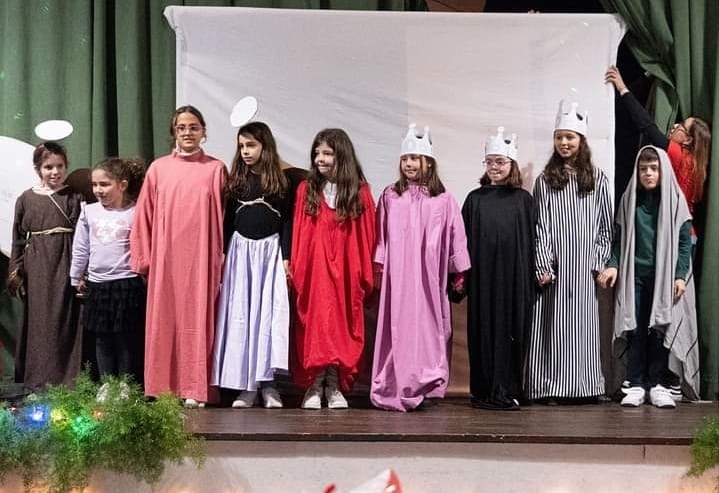 Preschool children in costumes performing a nativity play