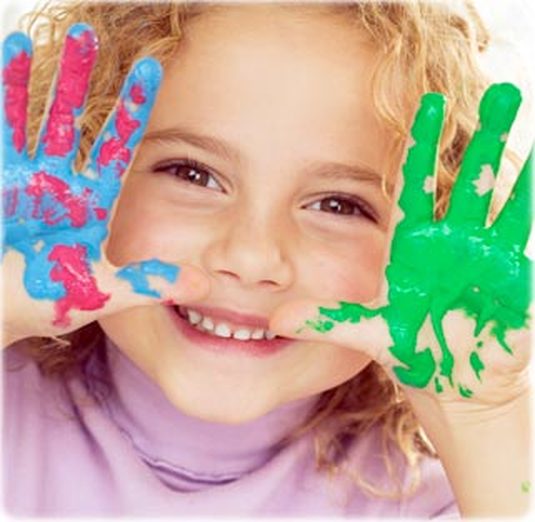 Preschool child with painted hands