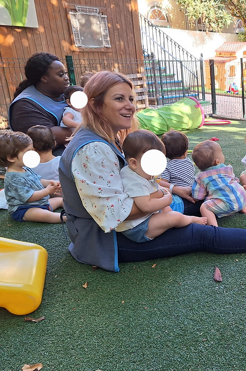 Preschool teacher with children in outdoor playground