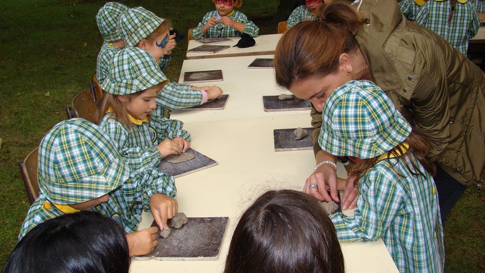 Preschool children participate in a clay modeling activity.