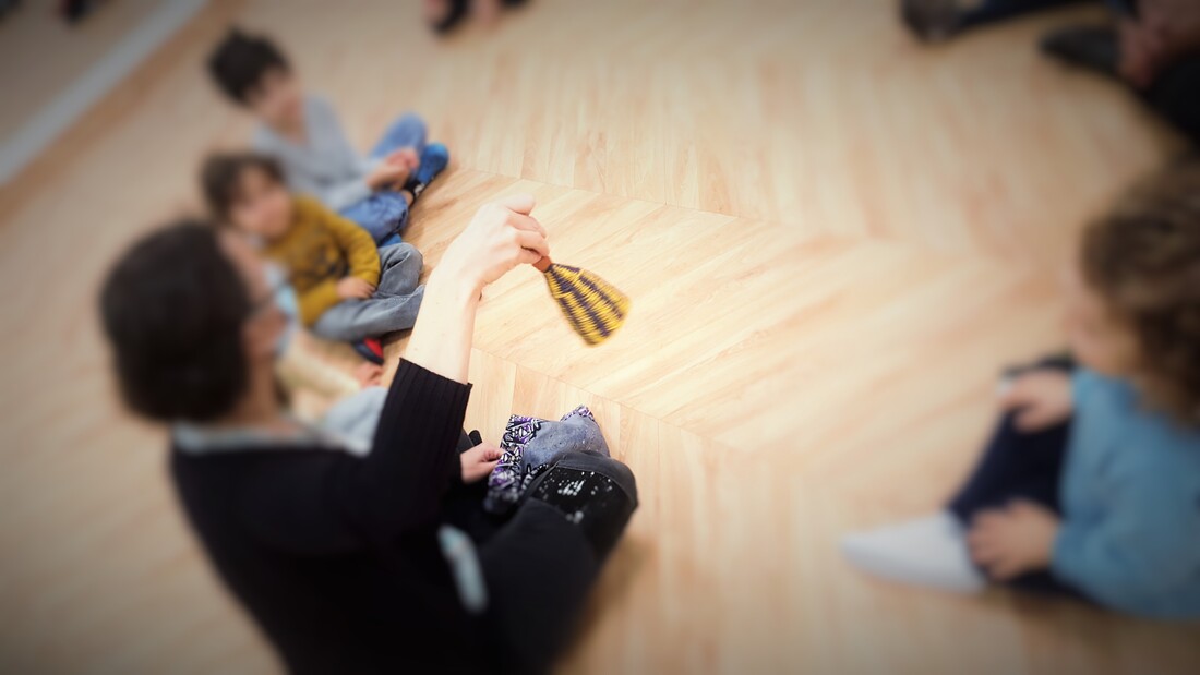 Preschool teacher playing music with children