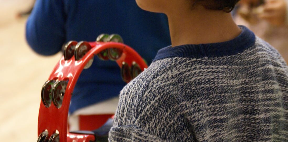 Child playing a tambourine