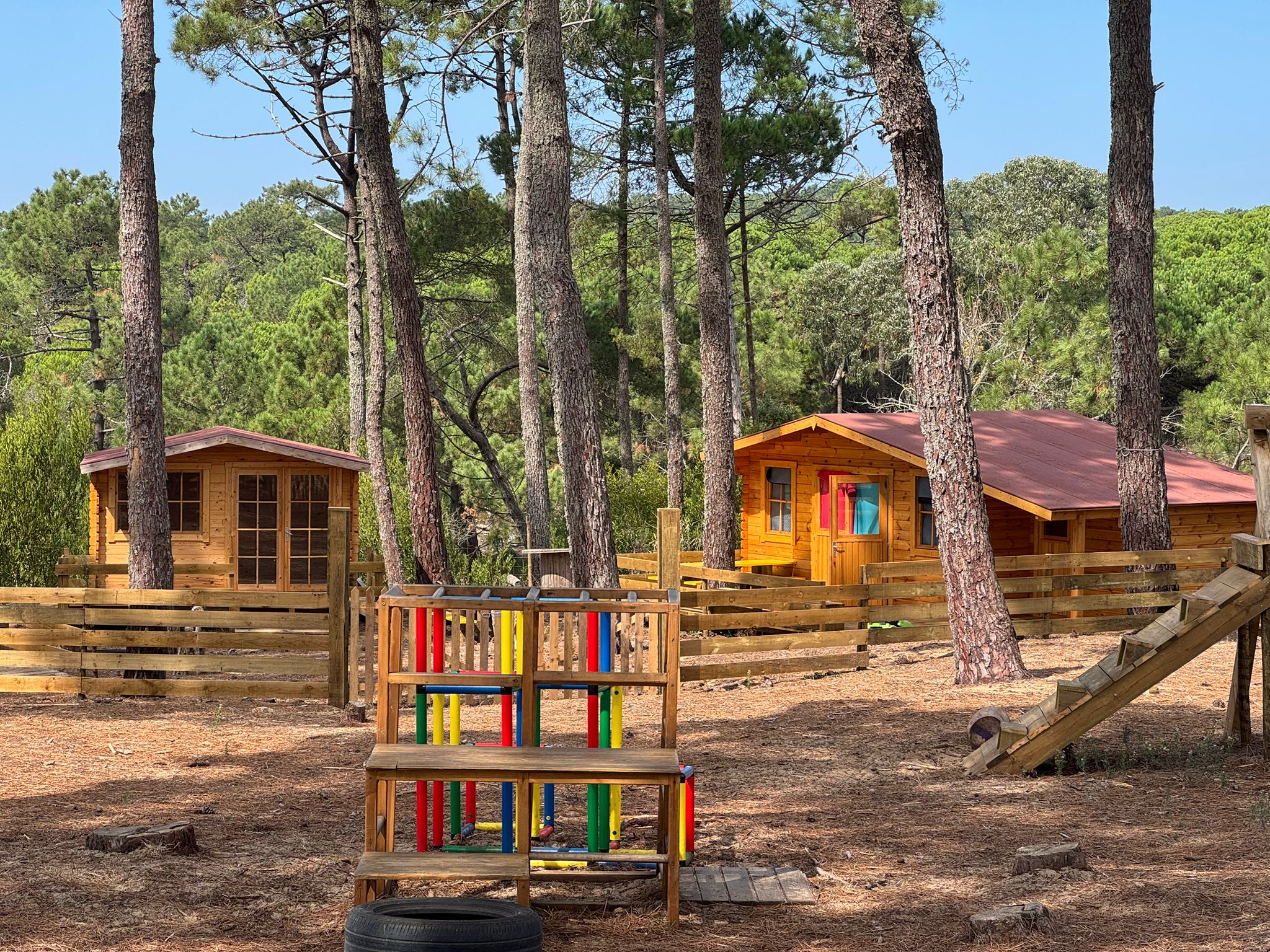 Wooden play structures and cabins at Cintra Tribus preschool
