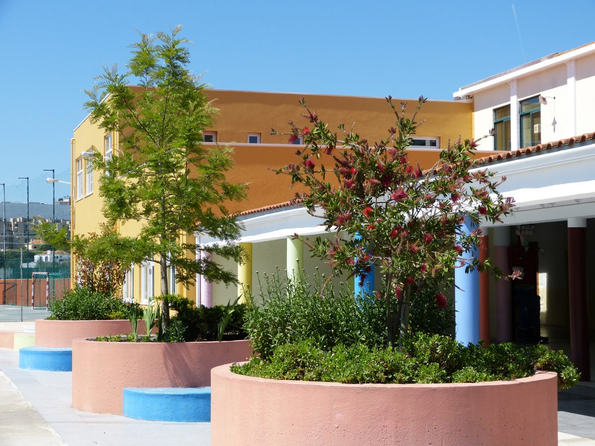 Colégio Vasco Da Gama school building exterior with colorful planters and landscaping