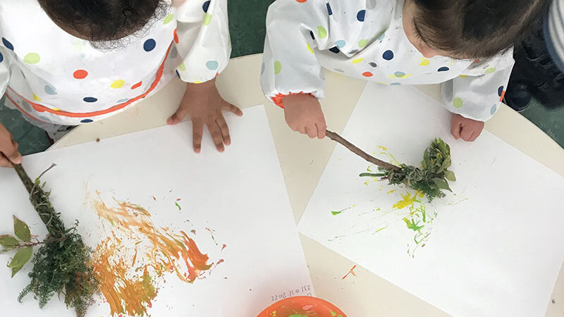 Preschool children creating nature art