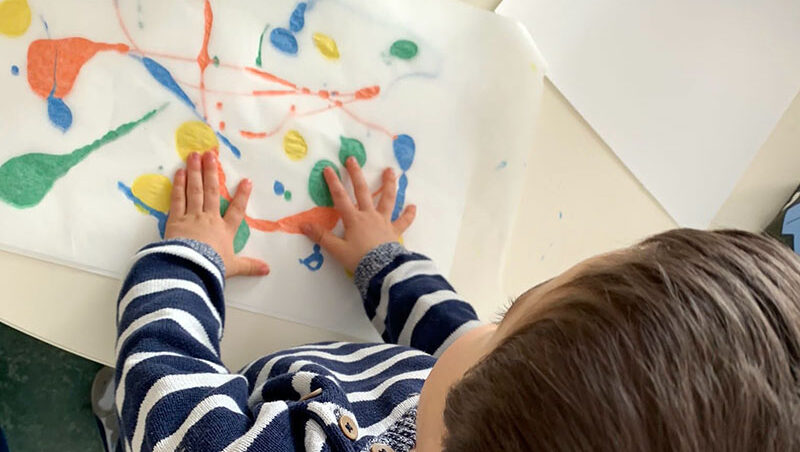 Preschool child creating colorful artwork