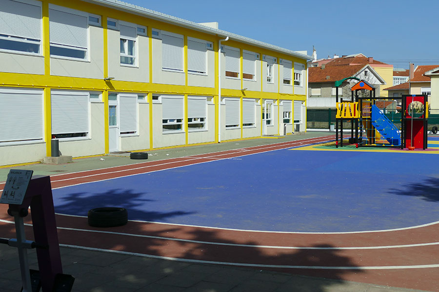 Preschool playground with colorful play equipment and running track
