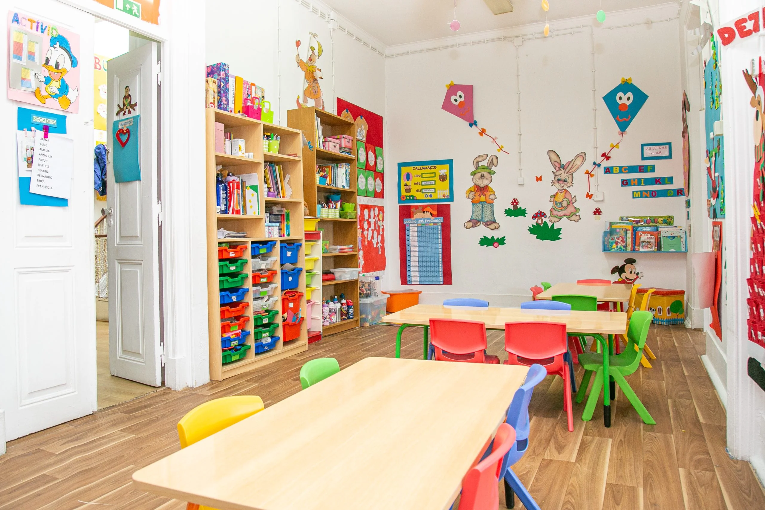 Preschool classroom with colorful furniture, books, and educational materials