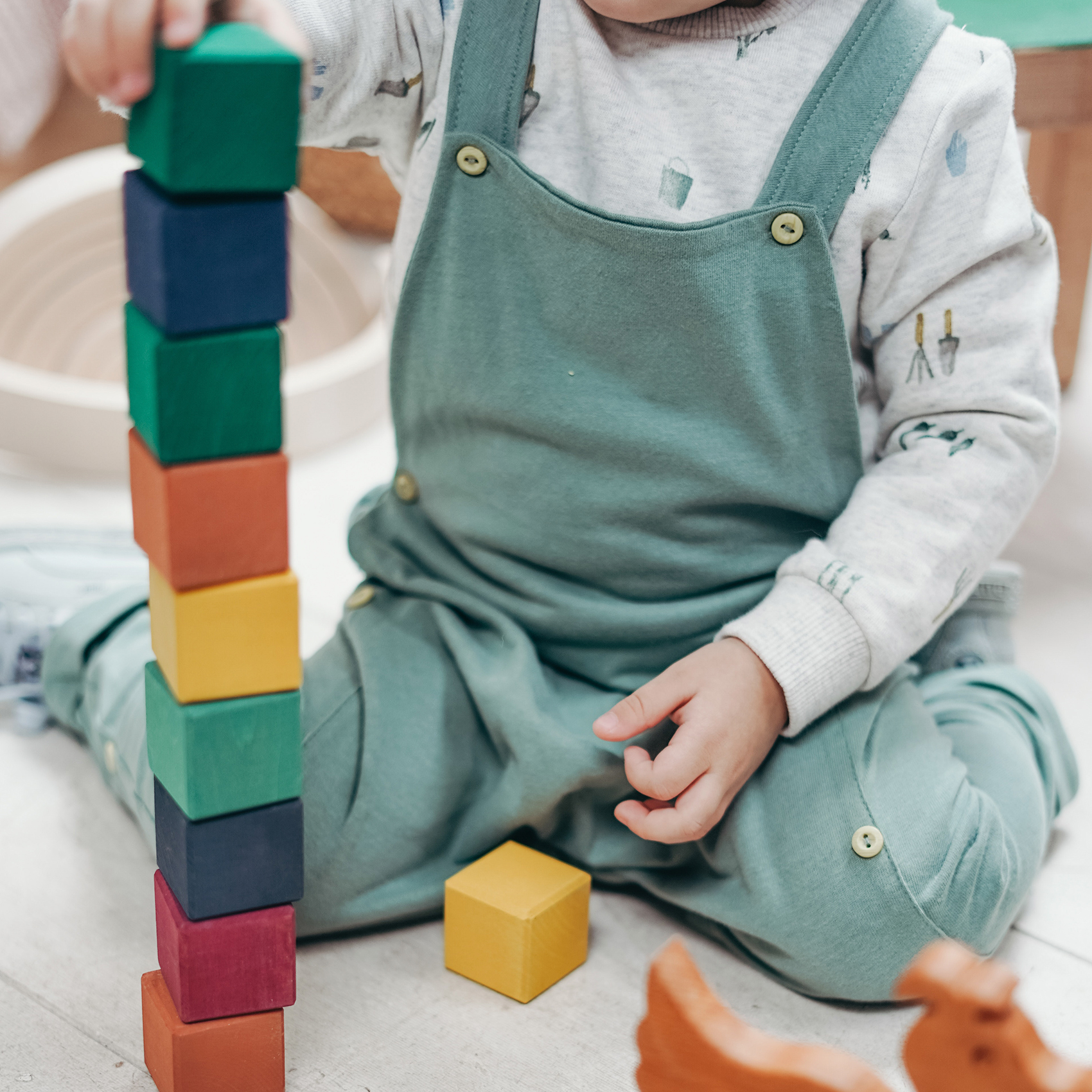 Child playing with colorful wooden blocks