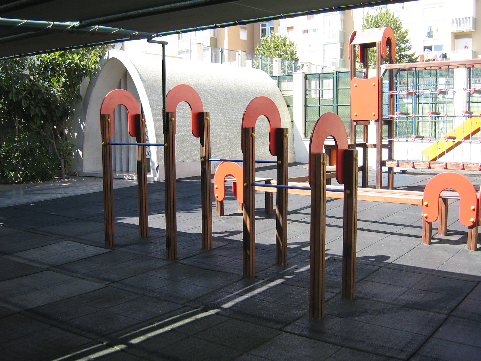 Preschool playground with wooden climbing bars and play structures