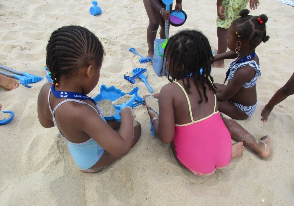 Preschool children playing with sand toys on a beach