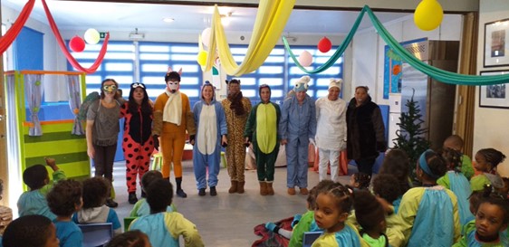Preschool children and teachers in costumes participating in a play or performance