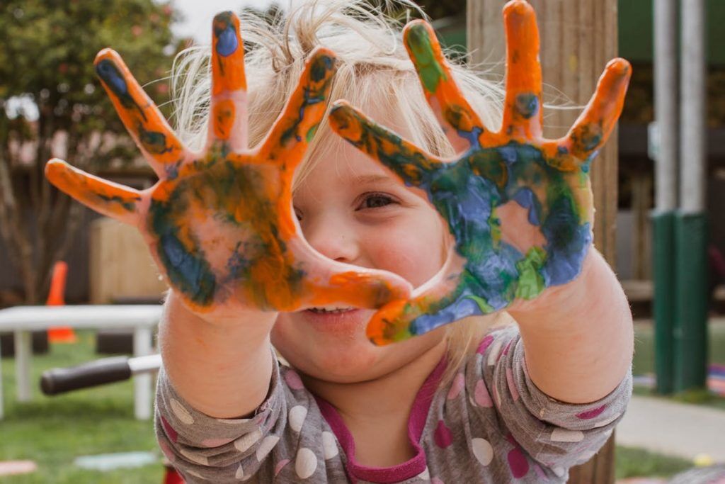 Preschool child with painted hands