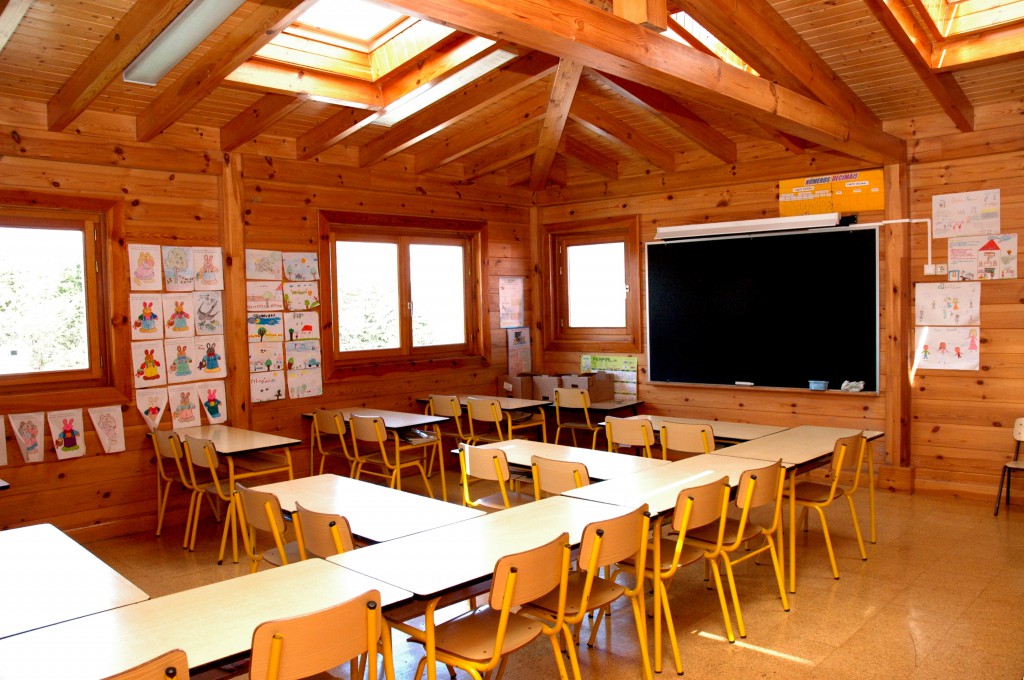 Preschool classroom with wooden walls and child-made artwork