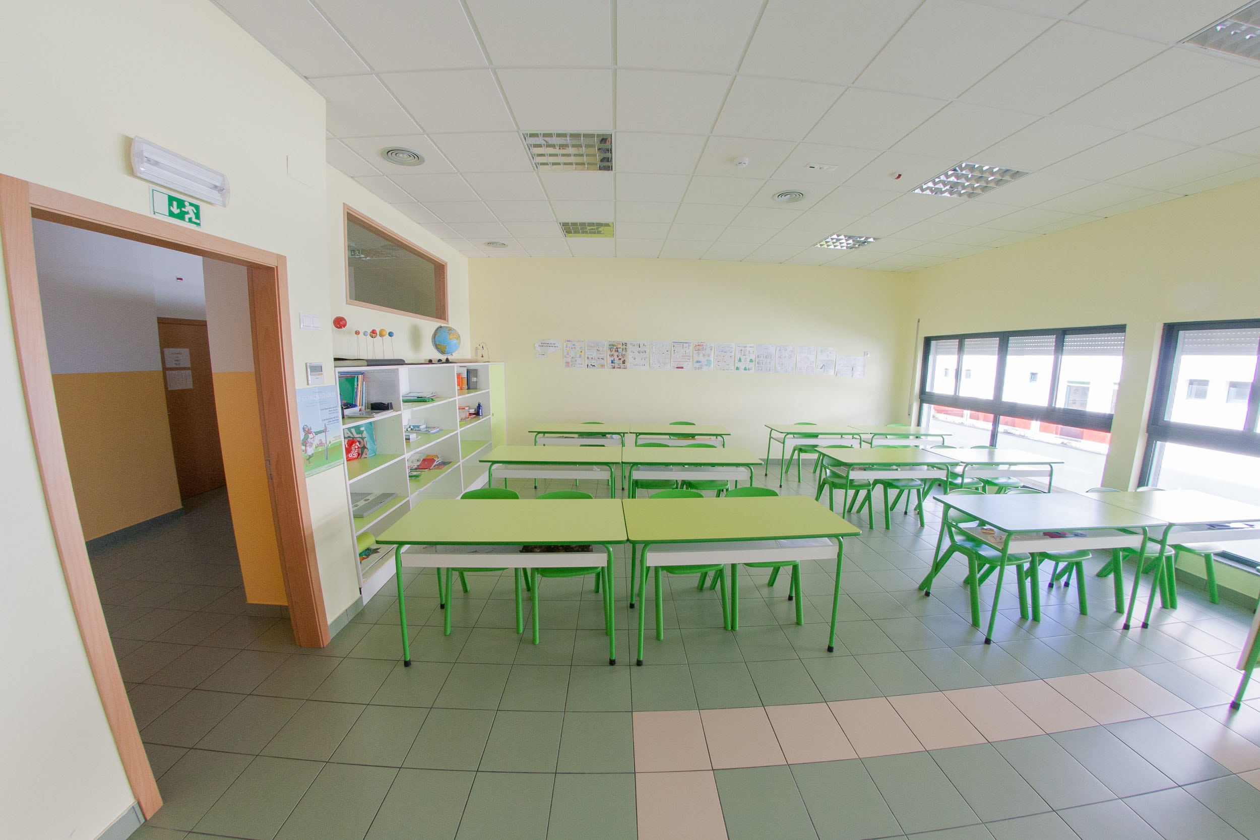 Preschool classroom with green tables and chairs