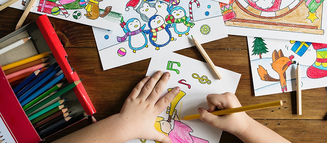 Preschool child coloring musical notes and a trumpet