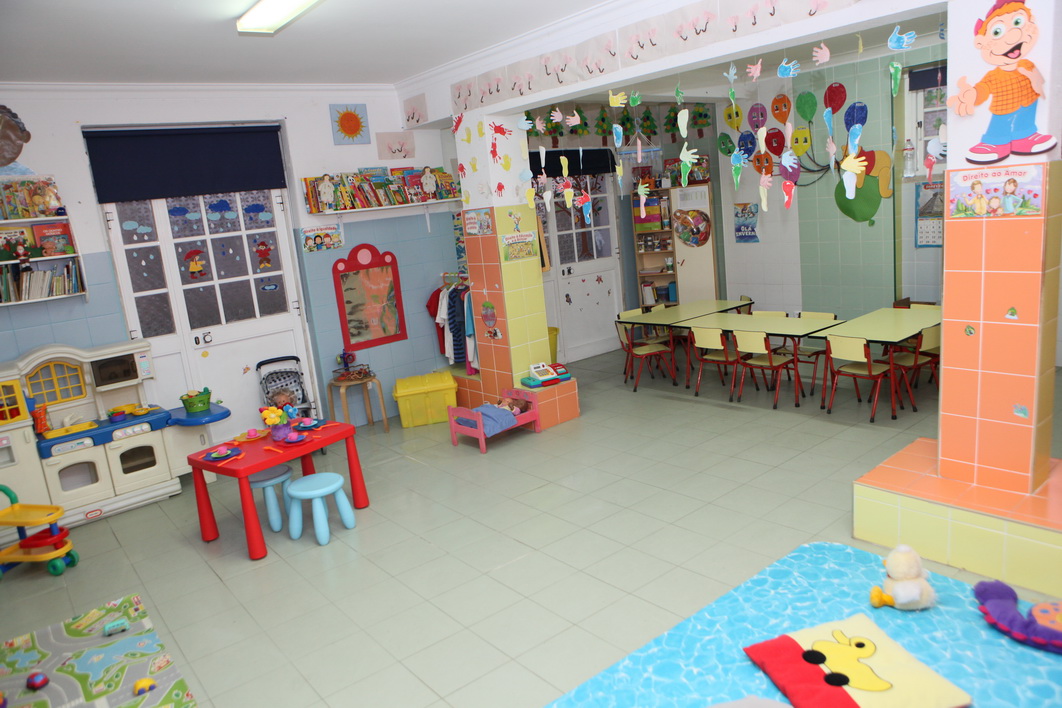 Preschool classroom with colorful furniture, toys, and decorations