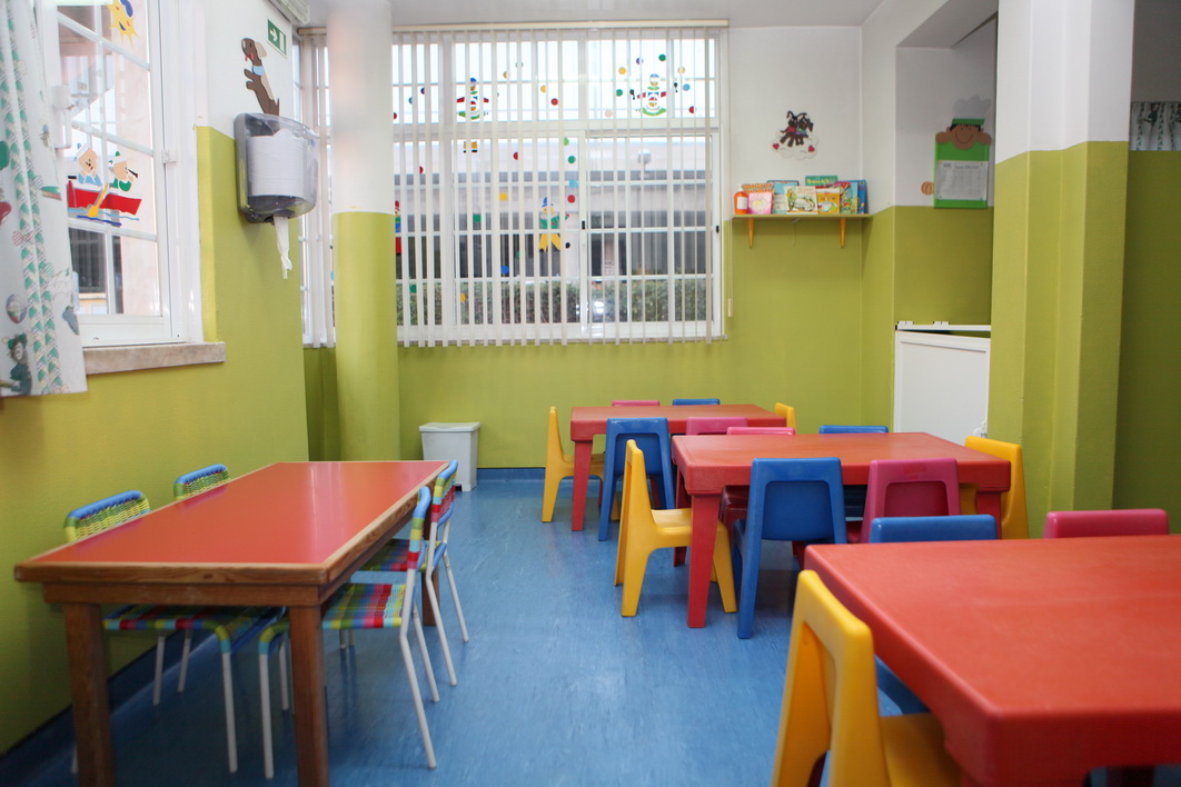 Preschool classroom with colorful tables and chairs