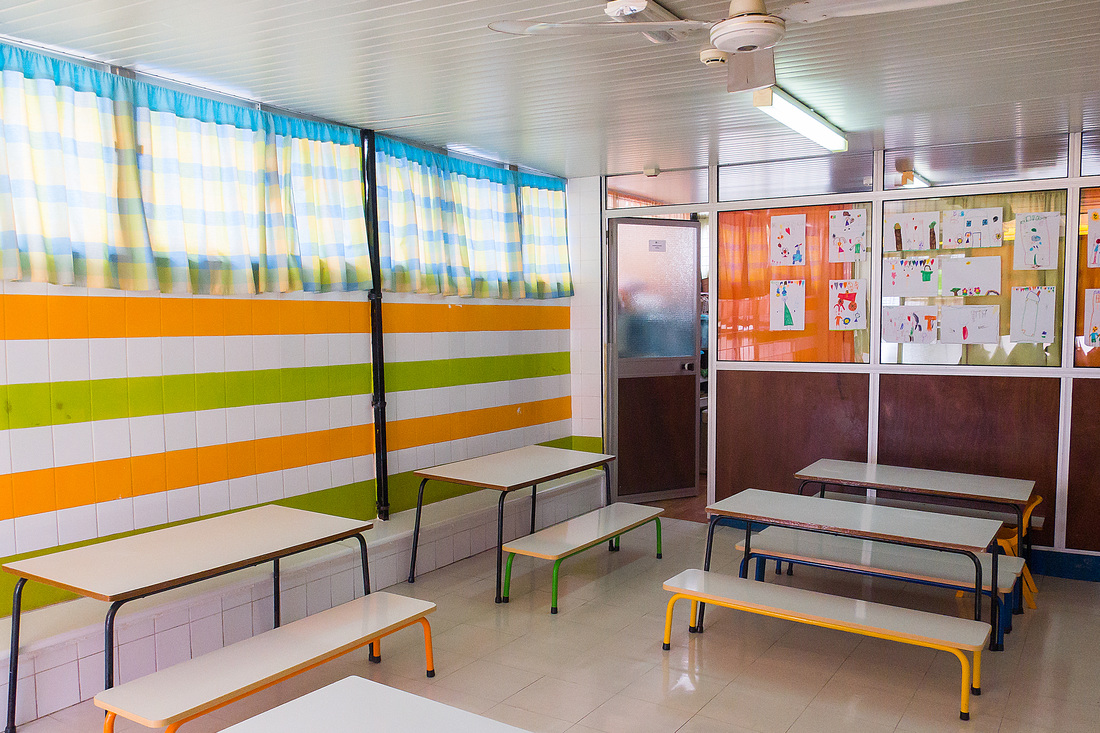 Preschool classroom with colorful walls and small tables and chairs