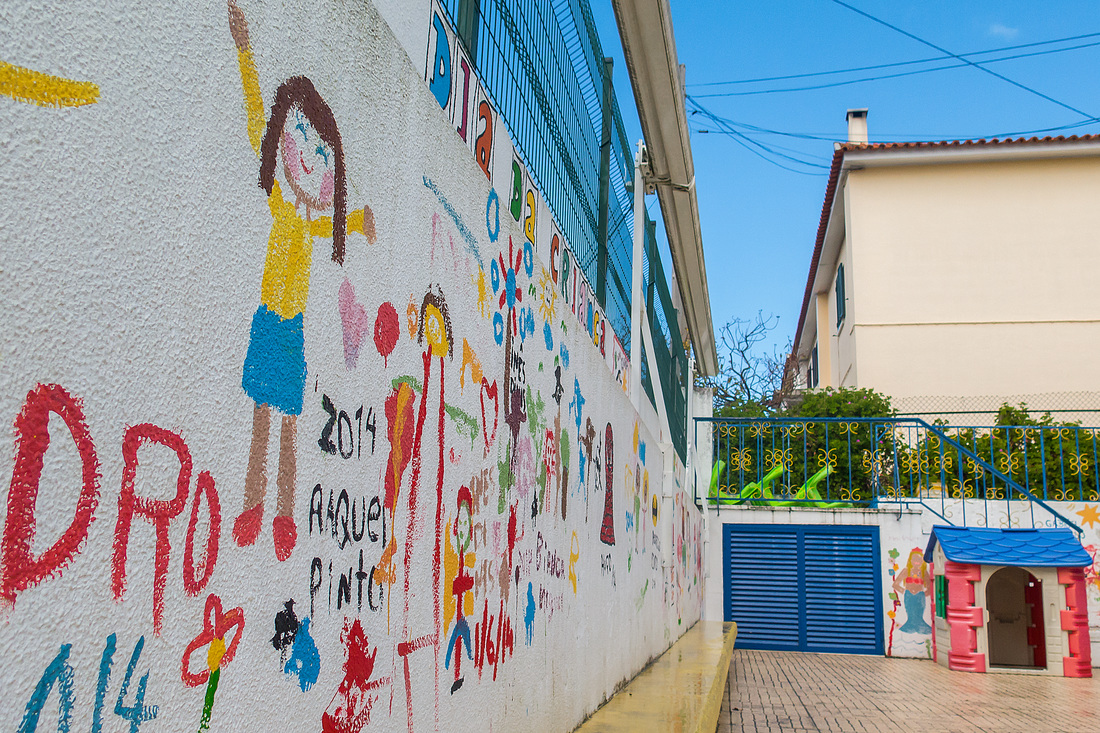 Colorful artwork painted on a wall by children at Kindergarten Caracol