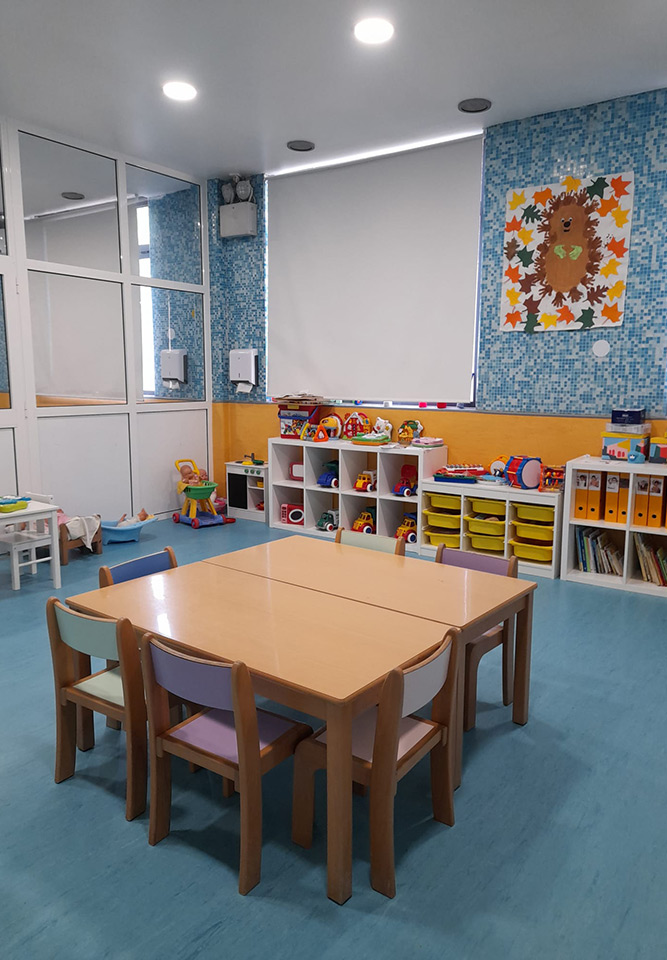 Preschool classroom with colorful toys and furniture
