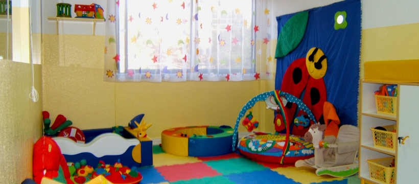 Preschool classroom with colorful toys and play equipment