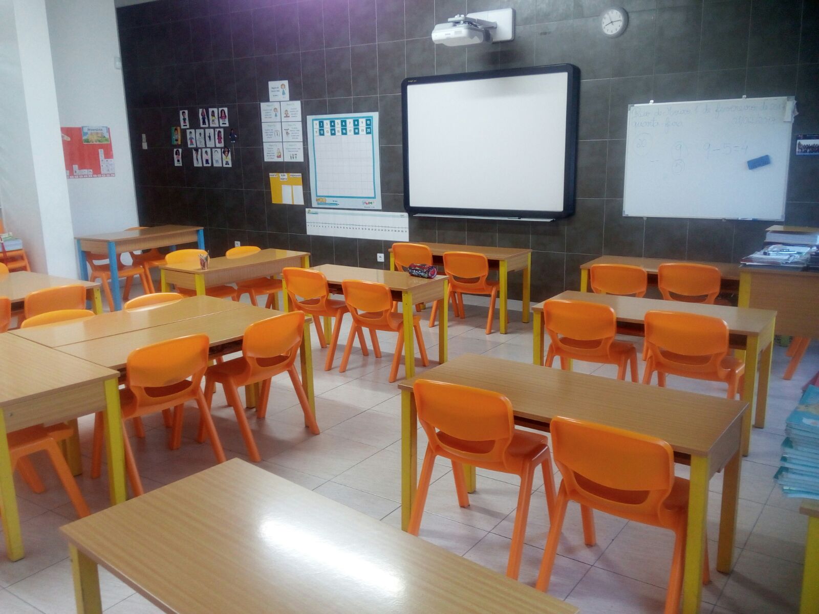 Preschool classroom with orange chairs and tables