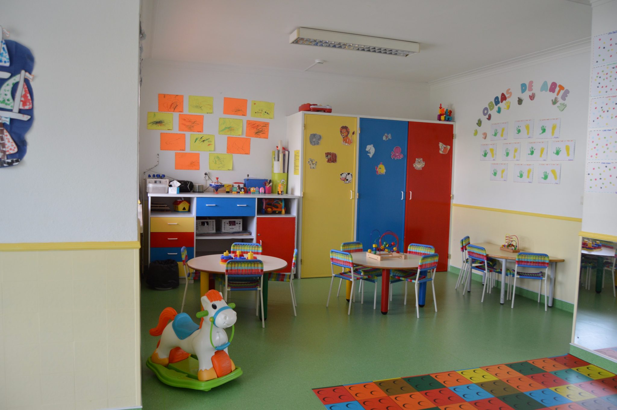 Preschool classroom with colorful furniture and children's artwork