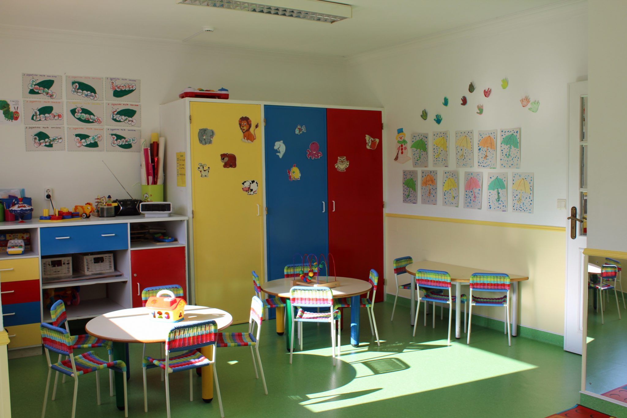 Preschool classroom with colorful furniture and children's artwork