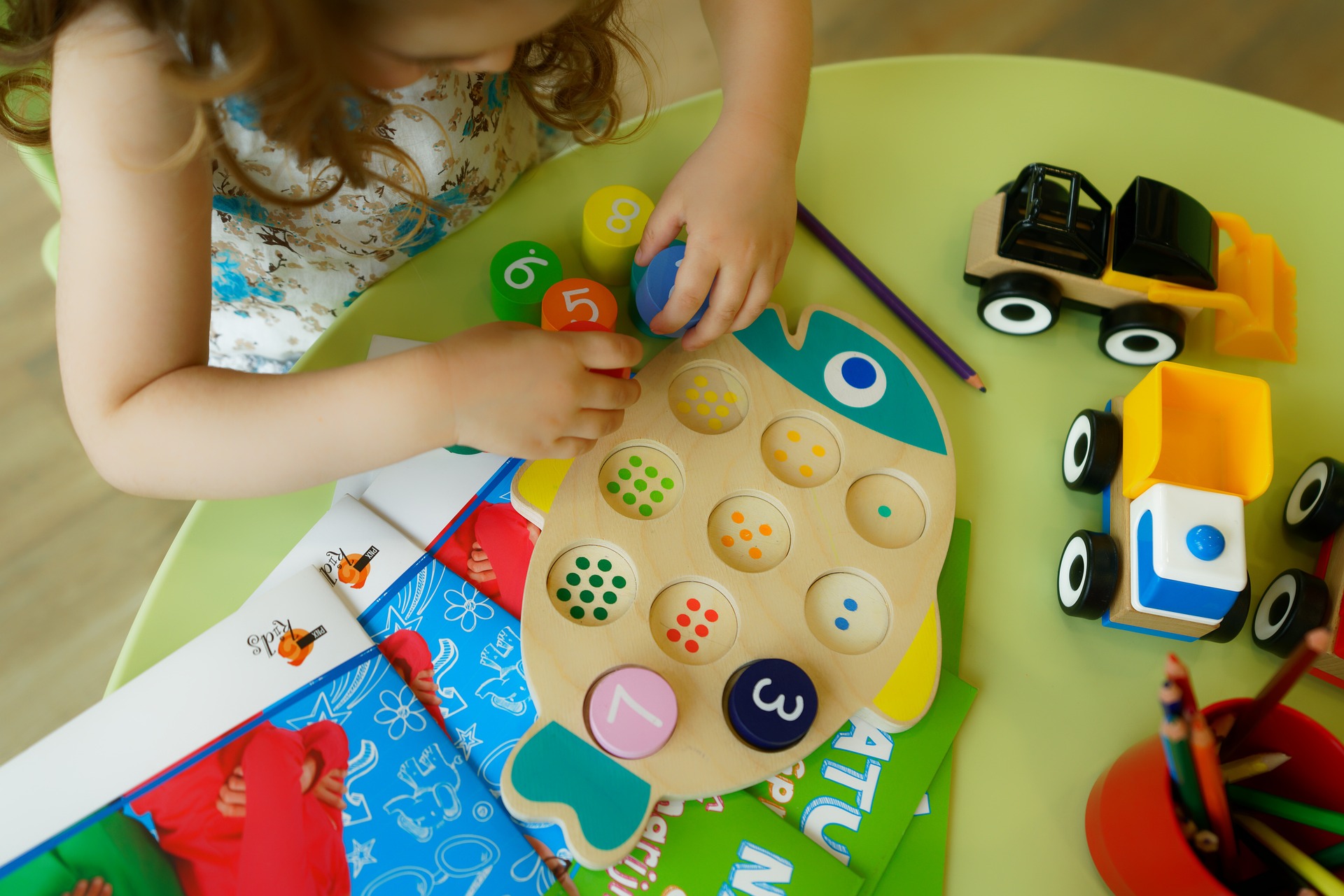 Preschool child playing with number and color matching toy