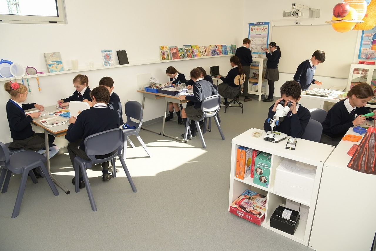 Students engaged in science experiments and learning activities at St. George's School.