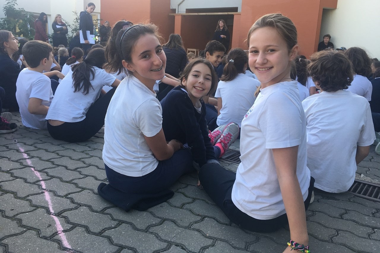 Students sitting on the ground at St. George's School