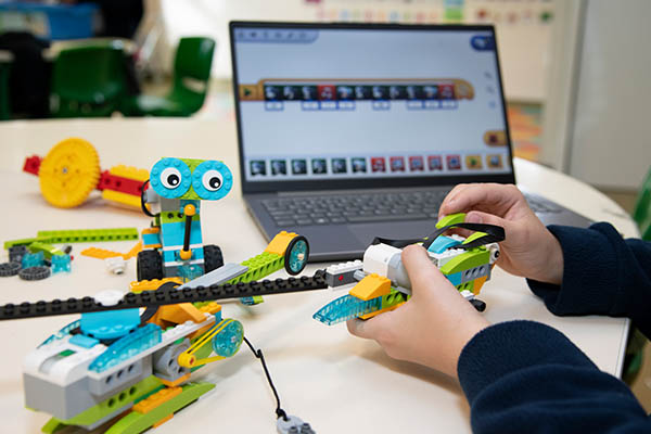 Preschool student building a robot with LEGO Education SPIKE Prime.