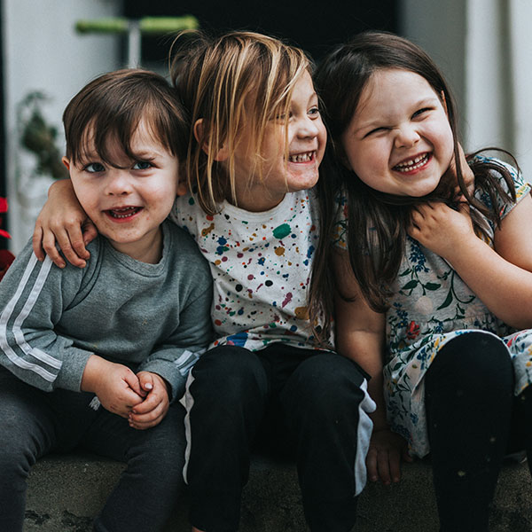 Happy preschool children embracing each other