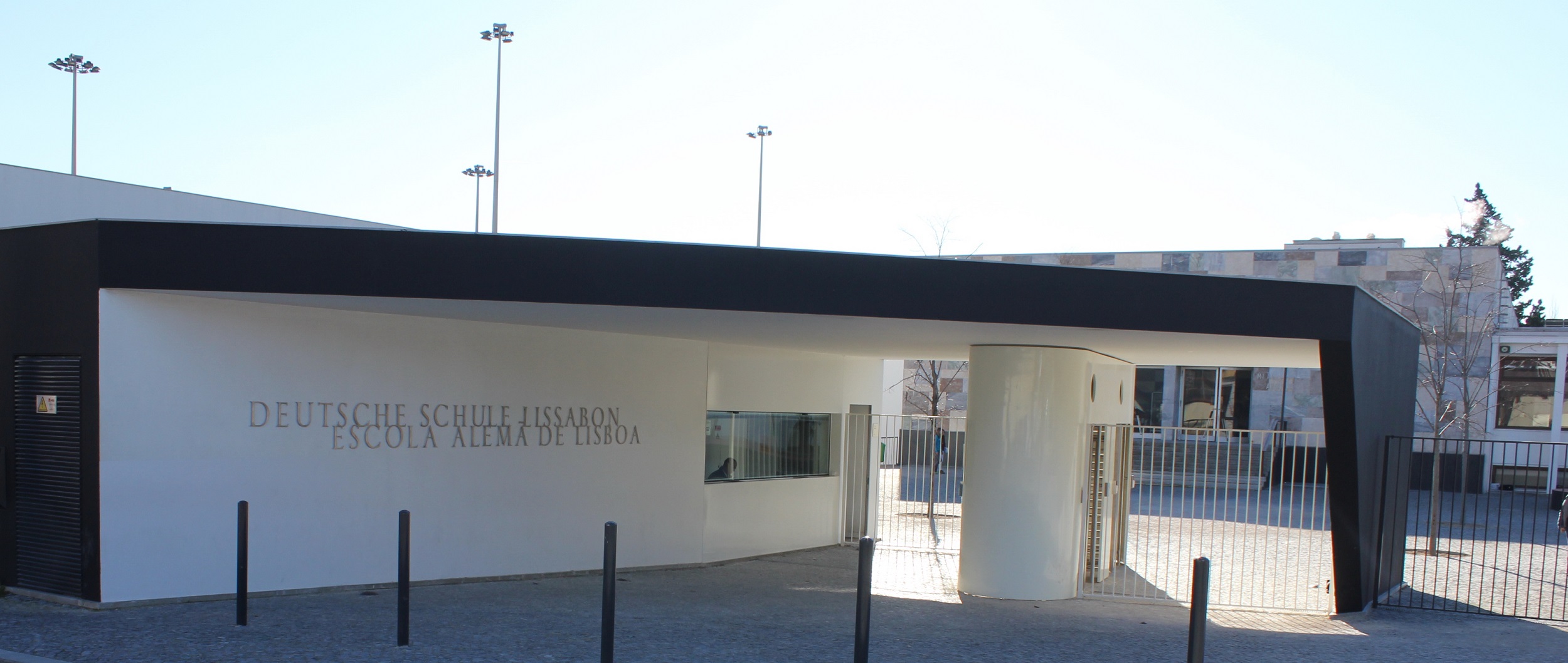 Entrance to Deutsche Schule Lissabon, a modern school building with black and white design.