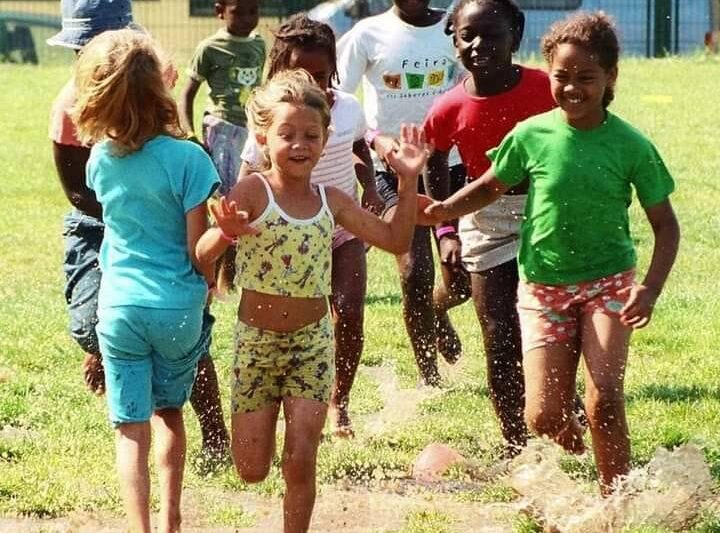 Preschool children playing outdoors on a sunny day