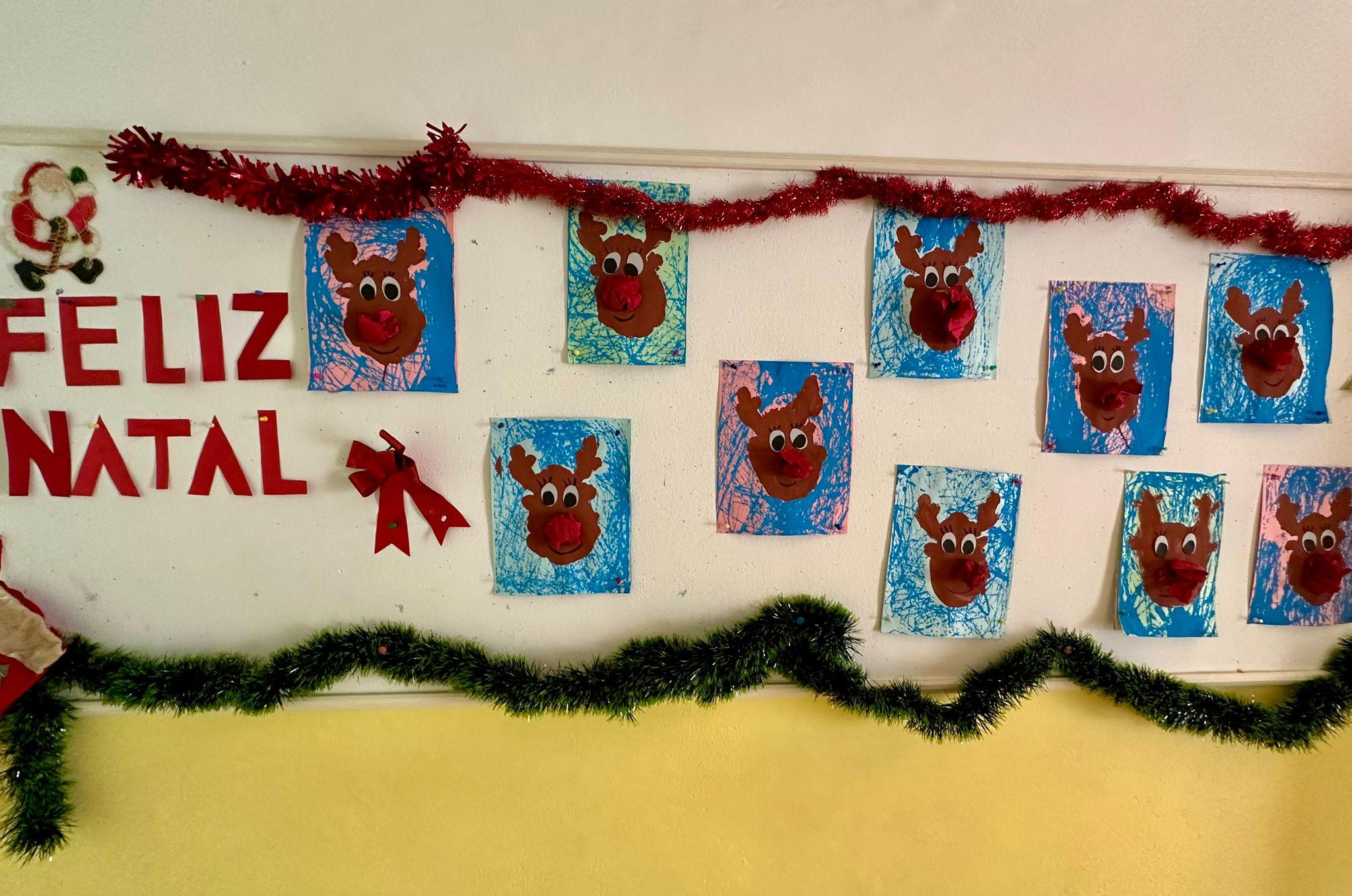 Children's artwork of reindeer faces on display at Academia AJEC for Christmas