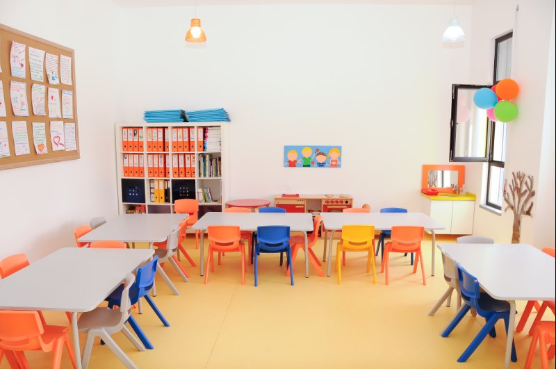 Preschool classroom with colorful tables and chairs
