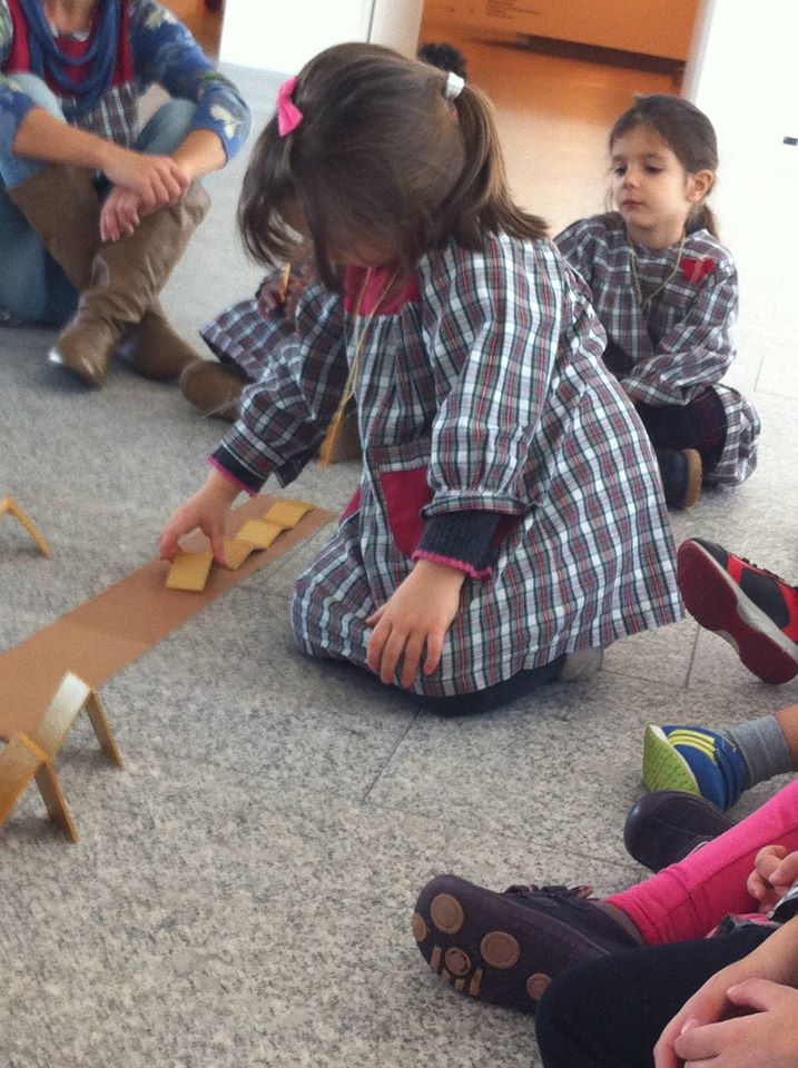 Preschool children playing with wooden blocks during class