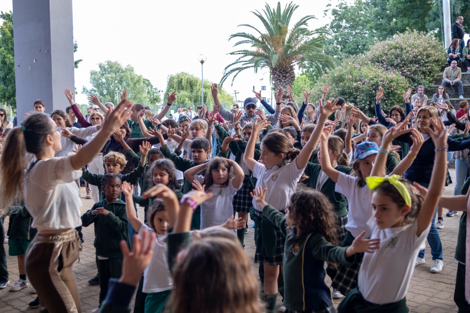 Preschool children participating in a lively dance or activity outdoors
