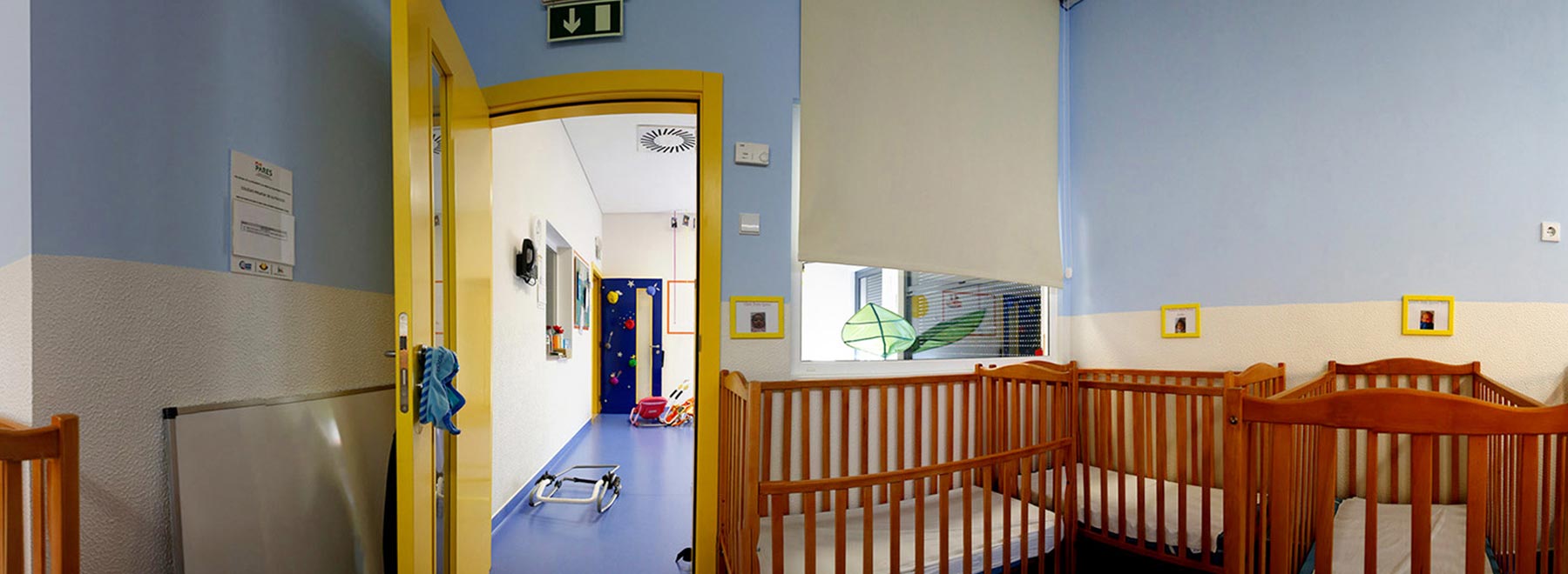 Preschool nursery with cribs and colorful walls