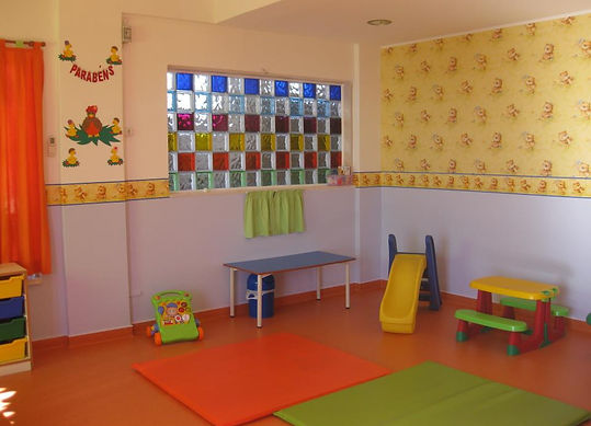 Preschool classroom with colorful toys and a play slide