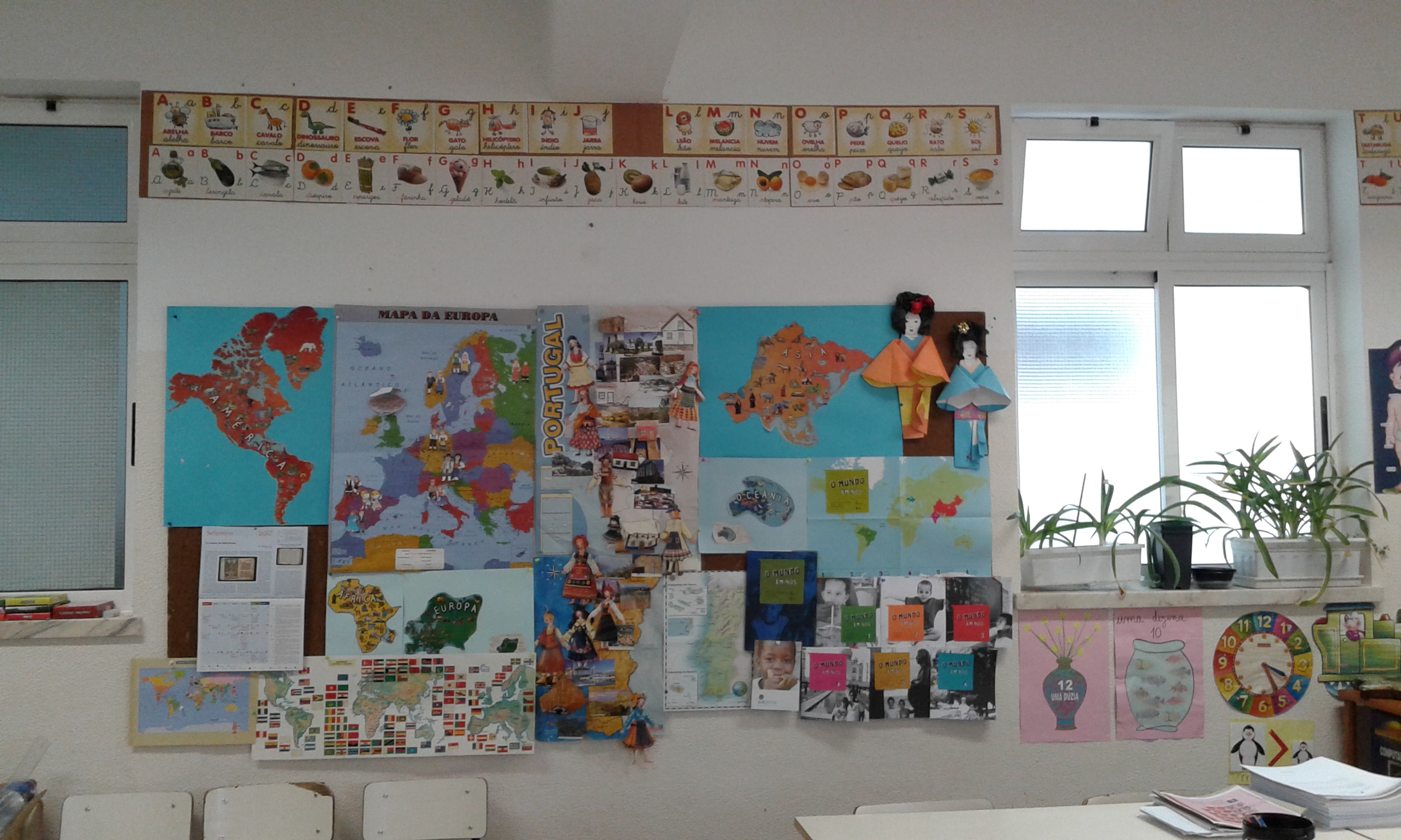 Preschool classroom with alphabet charts, maps, and student artwork