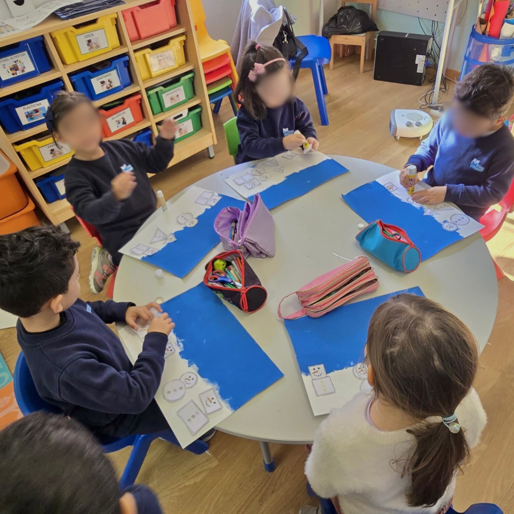 Preschool children making snowman crafts
