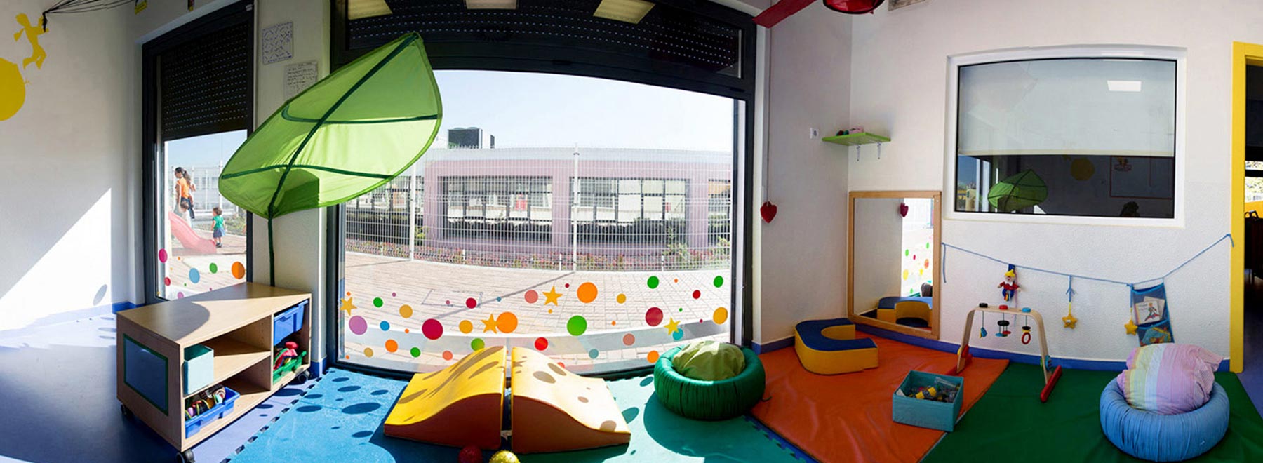 Preschool classroom with colorful play equipment and toys