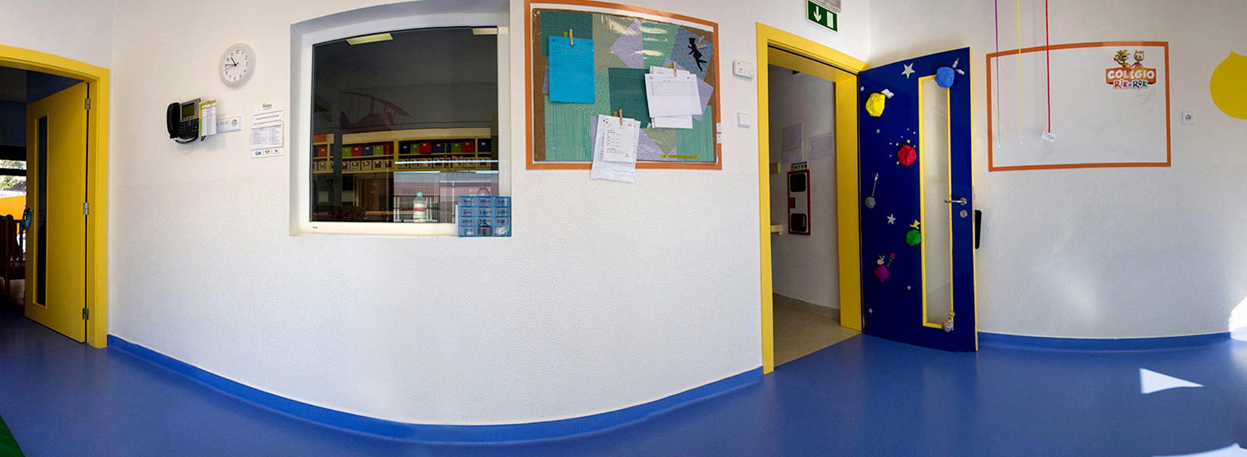 Preschool hallway with colorful doors and bulletin boards
